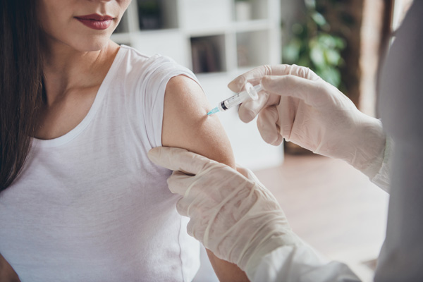 woman receiving shot in the arm